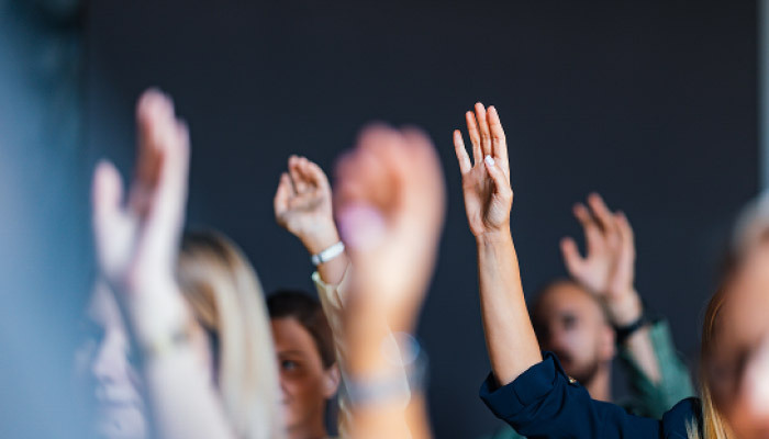 Group of people with raised hands
